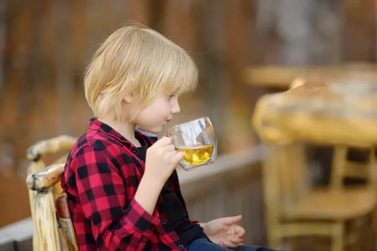 little boy drinking tea (image)